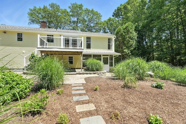 147 Mort Vining Rd, Southwick, MA 01077 - view of front facade with a chimney, a sunroom, and a balcony