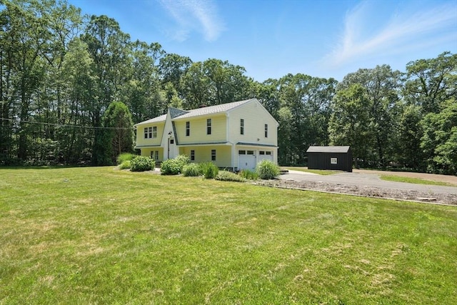 147 Mort Vining Rd, Southwick, MA 01077 - view of front facade with an attached garage, a storage shed, a front lawn, driveway, and view of wooded area