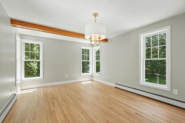 147 Mort Vining Rd, Southwick, MA 01077 - empty room featuring a baseboard radiator, light wood-style floors, and a chandelier