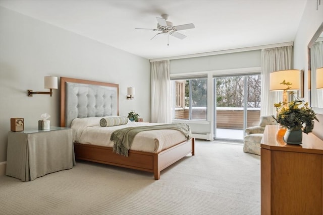 carpeted bedroom featuring ceiling fan, access to exterior, and a baseboard heating unit