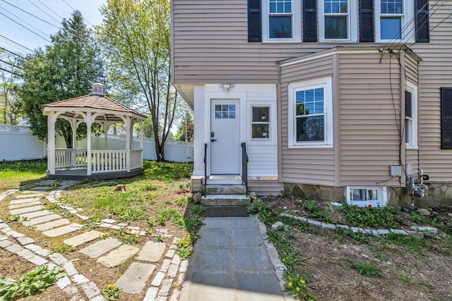doorway to property featuring fence