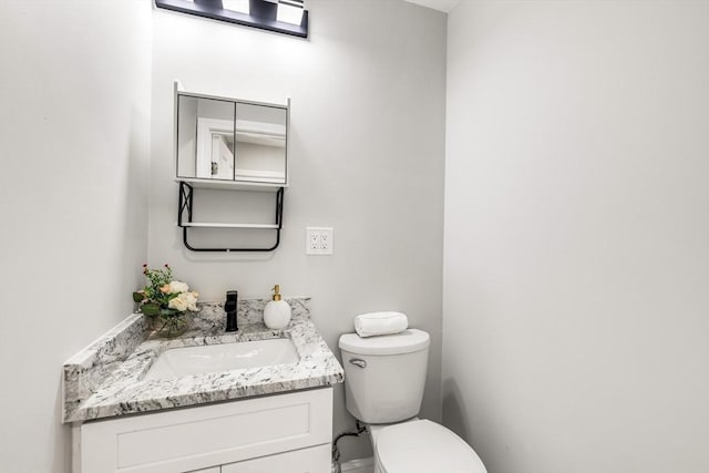 bathroom featuring toilet and vanity