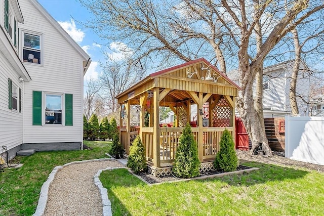 view of yard featuring fence, a wooden deck, and a gazebo