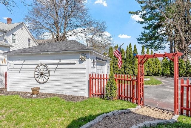 detached garage featuring fence