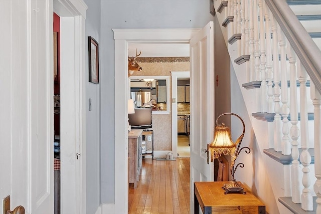 hall with light wood-style floors and stairs
