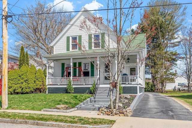 farmhouse inspired home with covered porch and a front yard
