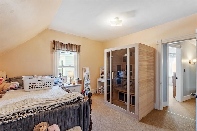 carpeted bedroom with baseboards and lofted ceiling