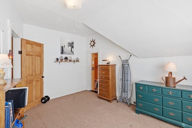 bedroom featuring light carpet and lofted ceiling