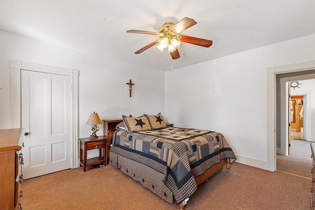 bedroom with ceiling fan and light carpet