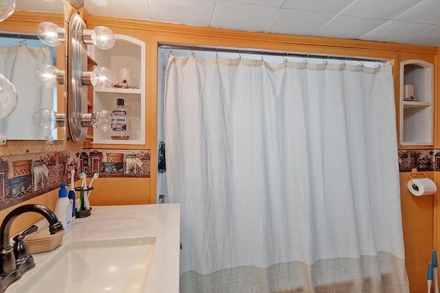 bathroom featuring a sink and a shower with shower curtain
