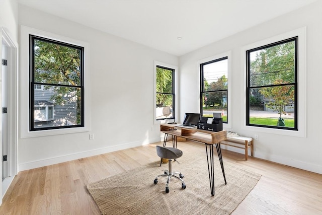 office area with light hardwood / wood-style floors