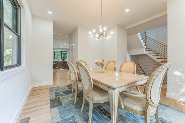 dining room featuring a chandelier and light wood-type flooring