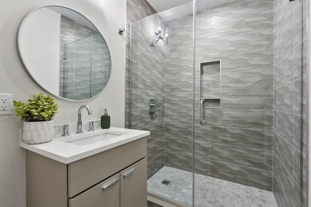 bathroom featuring vanity and an enclosed shower