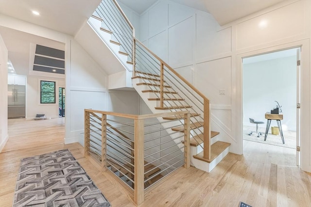 stairs featuring wood-type flooring