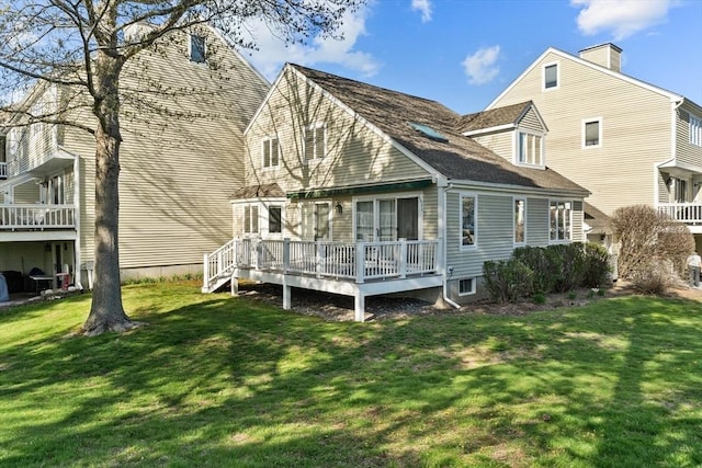 back of property featuring a yard and a deck