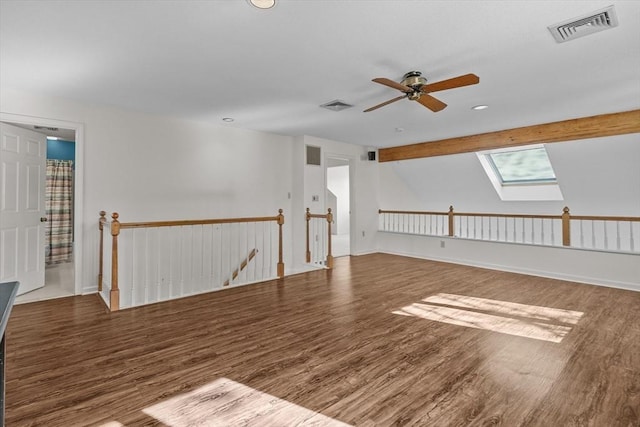 bonus room featuring ceiling fan, visible vents, a skylight, and wood finished floors