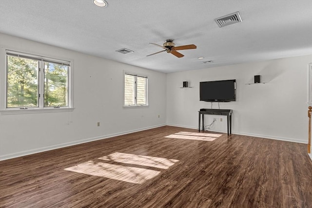 unfurnished living room featuring visible vents, a ceiling fan, and plenty of natural light