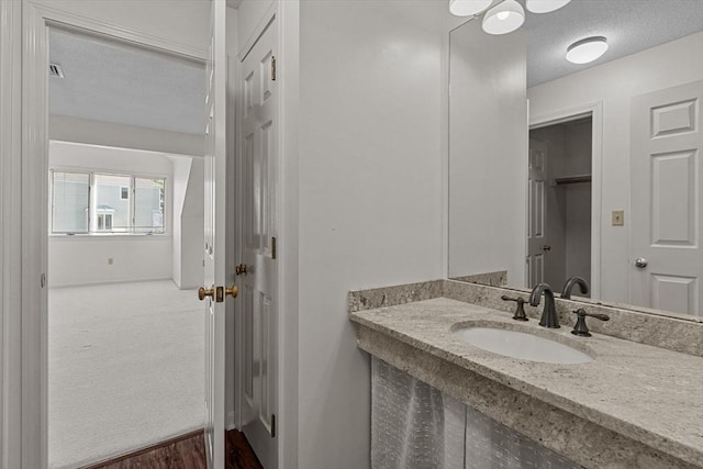 bathroom with a textured ceiling and a sink