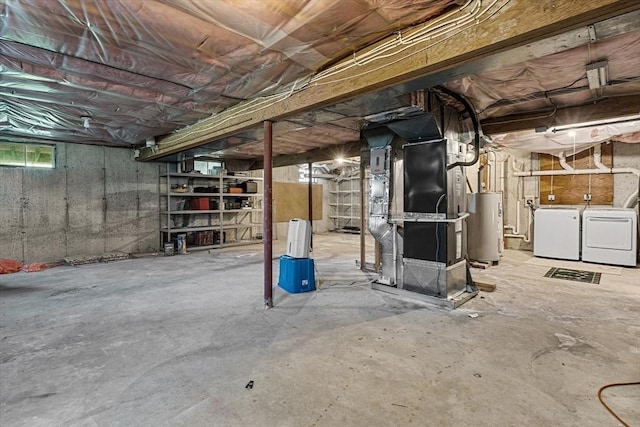 basement featuring water heater, heating unit, and washing machine and dryer