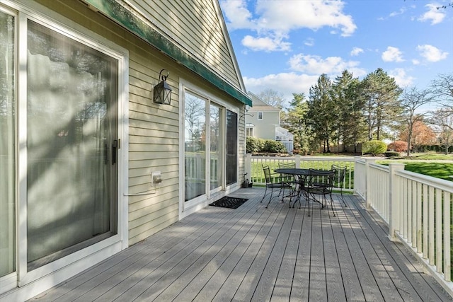 wooden deck featuring outdoor dining space