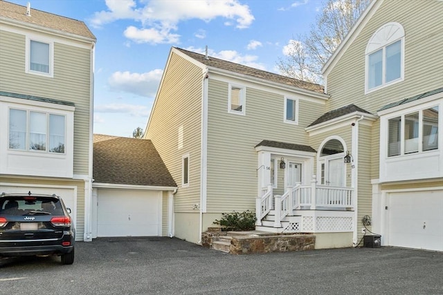 view of front facade with a garage and aphalt driveway