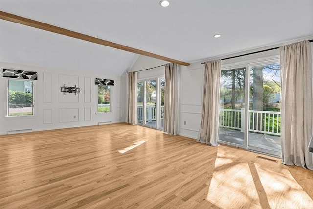 unfurnished living room with visible vents, a decorative wall, vaulted ceiling with beams, light wood-type flooring, and a baseboard heating unit
