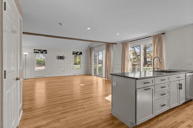 kitchen with a sink, plenty of natural light, light wood-style floors, and open floor plan