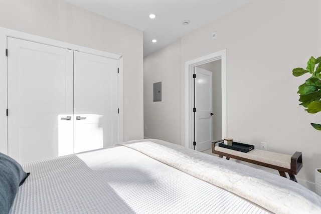 bedroom with electric panel, a closet, and recessed lighting