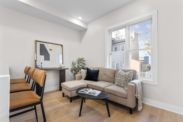 living room with recessed lighting, light wood-style flooring, and baseboards