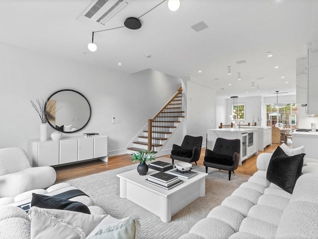 565 E Broadway, Boston, MA 02127 - living room with light wood-style floors, stairs, wine cooler, and recessed lighting
