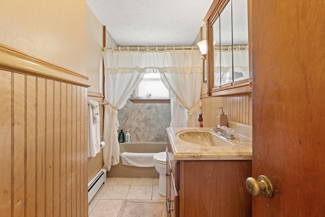 full bathroom with tile patterned flooring, baseboard heating, vanity, toilet, and a tub to relax in