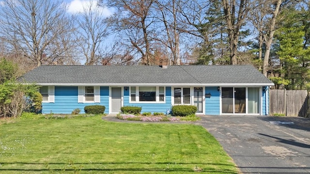 single story home featuring fence and a front yard