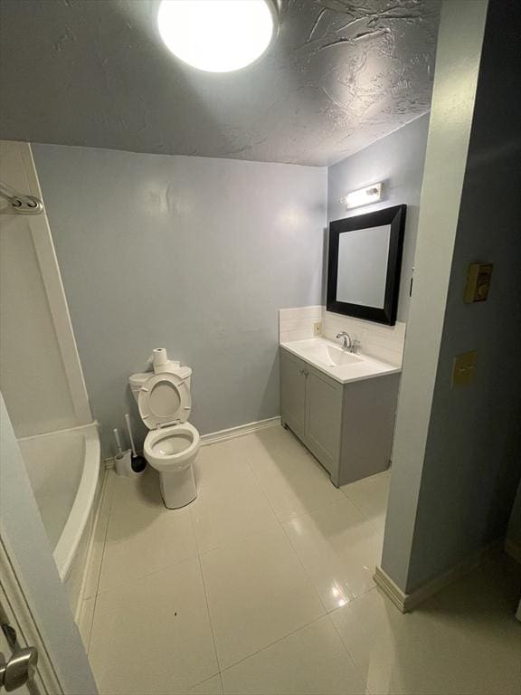 bathroom featuring tile patterned floors, vanity, and toilet