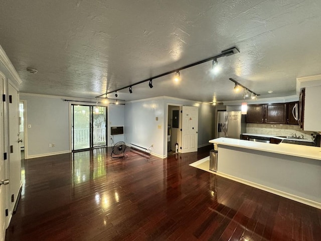 kitchen with dark brown cabinetry, a baseboard radiator, stainless steel appliances, dark hardwood / wood-style floors, and track lighting