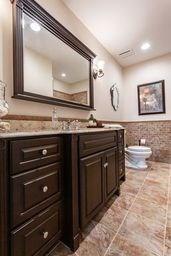 bathroom with vanity, recessed lighting, a wainscoted wall, toilet, and tile walls