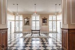 interior space featuring tile patterned floors, a healthy amount of sunlight, decorative columns, and ornamental molding