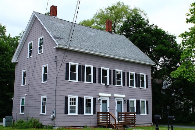 34-36 Glenallen St, Winchendon, MA 01475 - view of front of house with a chimney, roof with shingles, and a front lawn