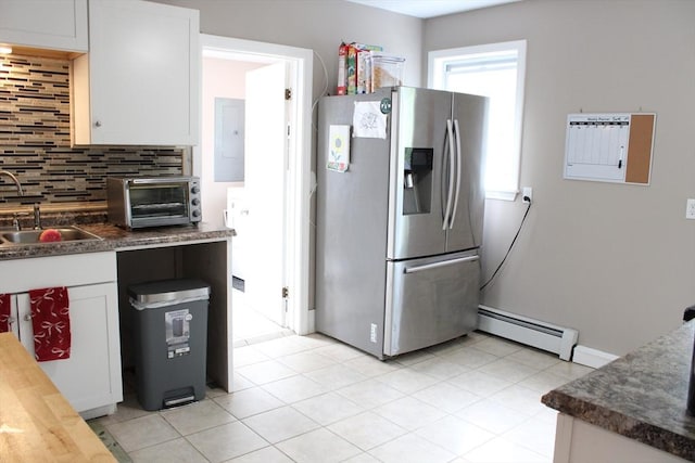 34-36 Glenallen St, Winchendon, MA 01475 - kitchen with stainless steel fridge with ice dispenser, a baseboard heating unit, electric panel, tasteful backsplash, and white cabinets