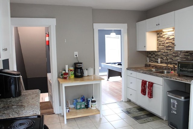 34-36 Glenallen St, Winchendon, MA 01475 - kitchen featuring tasteful backsplash, white cabinets, light tile patterned floors, dark countertops, and electric range