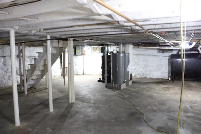 34-36 Glenallen St, Winchendon, MA 01475 - unfinished basement with heating fuel, stairs, water heater, and electric panel