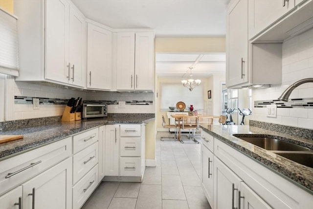 17 Chandler Rd, Malden, MA 02148 - kitchen featuring a sink, tasteful backsplash, white cabinets, and light tile patterned floors