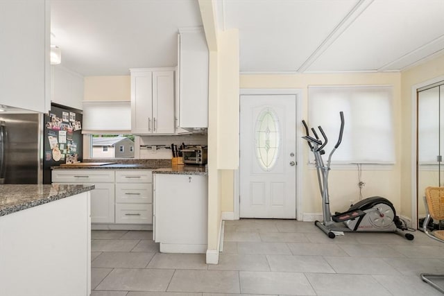 17 Chandler Rd, Malden, MA 02148 - kitchen featuring freestanding refrigerator, white cabinetry, light tile patterned floors, and backsplash