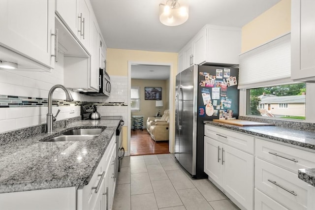 17 Chandler Rd, Malden, MA 02148 - kitchen with a sink, freestanding refrigerator, white cabinetry, light tile patterned floors, and tasteful backsplash