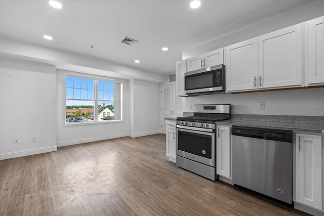 693 Western Ave Unit 404, Lynn, MA 01905 - kitchen featuring stainless steel appliances, wood finished floors, recessed lighting, baseboards, and white cabinetry