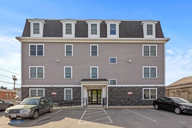693 Western Ave Unit 404, Lynn, MA 01905 - view of building exterior with uncovered parking