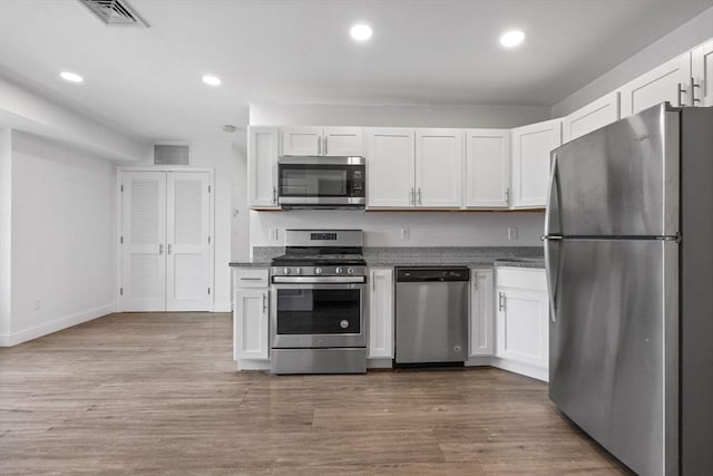693 Western Ave Unit 404, Lynn, MA 01905 - kitchen with appliances with stainless steel finishes, white cabinets, recessed lighting, and dark stone counters