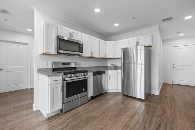 693 Western Ave Unit 404, Lynn, MA 01905 - kitchen featuring stainless steel appliances, white cabinetry, dark wood-type flooring, recessed lighting, and baseboards