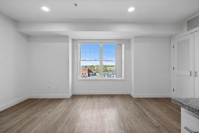 693 Western Ave Unit 404, Lynn, MA 01905 - unfurnished living room featuring wood finished floors, baseboards, and recessed lighting