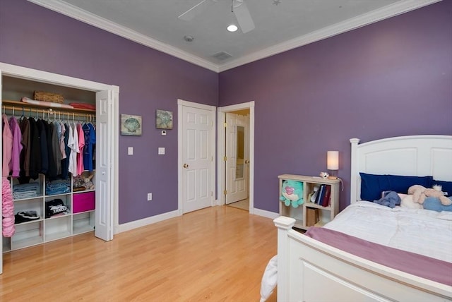 bedroom with a closet, ornamental molding, baseboards, a ceiling fan, and light wood-style flooring