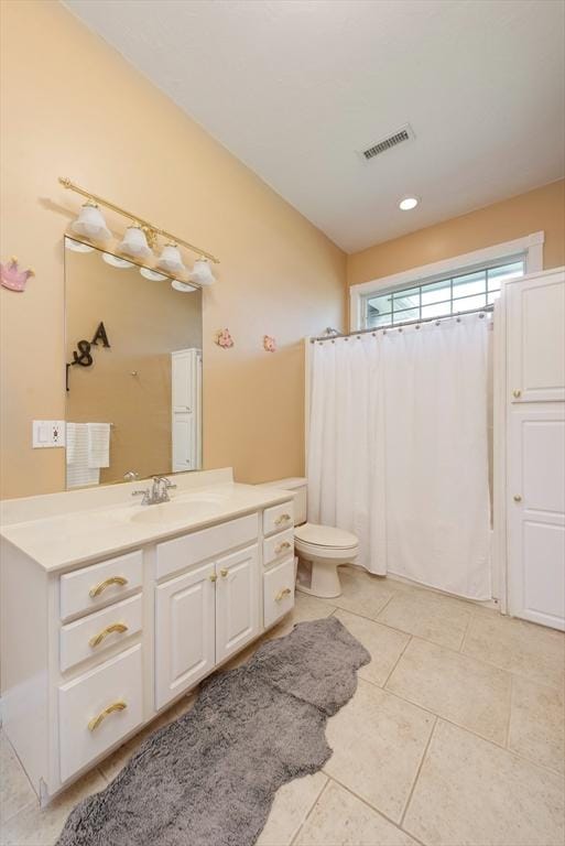 full bathroom with a shower with curtain, visible vents, vanity, tile patterned floors, and toilet